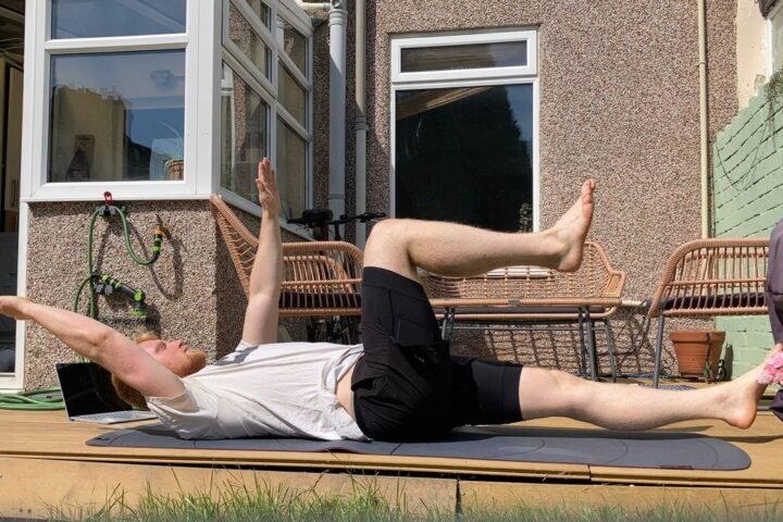 Author Harry Bullmore performing the dead bug exercise outside
