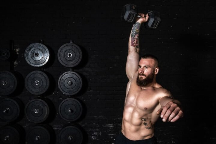 Man performs dumbbell snatch