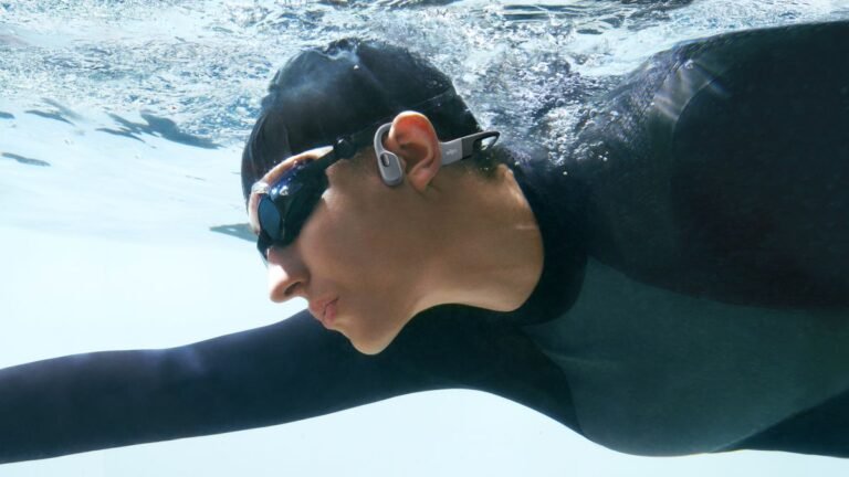 Swimmer wearing Shokz OpenSwim Pro headphones
